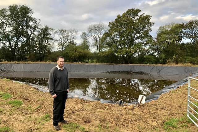 Farm and Farm Shop owner Graham Collett in front of the water reservoir.