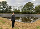 Farm and Farm Shop owner Graham Collett in front of the water reservoir.