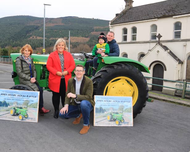 The Sloan family bring Francis' John Deere 1020 to present to the winner, l-r Rosemary, Orla, David, Grandson Daithi and Conor. It was Francis’ dying wish to raise money for Life and Time and S.A. Hospice and they each received £20,250.