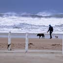 Unsettled weather continued to batter the North Coast of Northern Ireland on Tuesday. A dog walker on Benone Beach Co Londonderry. Image: Steven McAuley/McAuley Multimedia