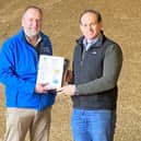 Simon Best winner of best winter oat yield in 2021 YEN with local CAFRE crops development adviser Iain Johnston.