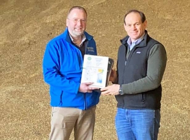 Simon Best winner of best winter oat yield in 2021 YEN with local CAFRE crops development adviser Iain Johnston.