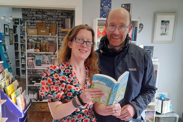 Holly and Paul Crawford with their book in The Secret Bookshelf, Carrickfergus