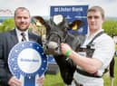 Conor McNeill, Ulster Bank business manager, presents Andrew Patterson, Crumlin, with the champion Holstein award at Balmoral Show 2010. Picture: Cliff Donaldson