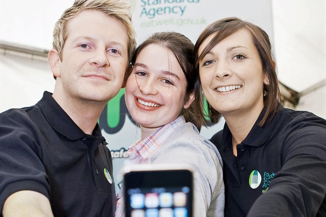 Anthony Higgins and Cathy McDowell, from the Food Standards Agency, present Greenmount student Aimee Louise Leslie (centre), from Londonderry, with an iPod Touch after she won a FSA competition at Balmoral Show 2010. Picture: Cliff Donaldson