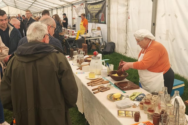 Demonstrating traditional butter making in the Shanes Castle Steam Rally craft tent
