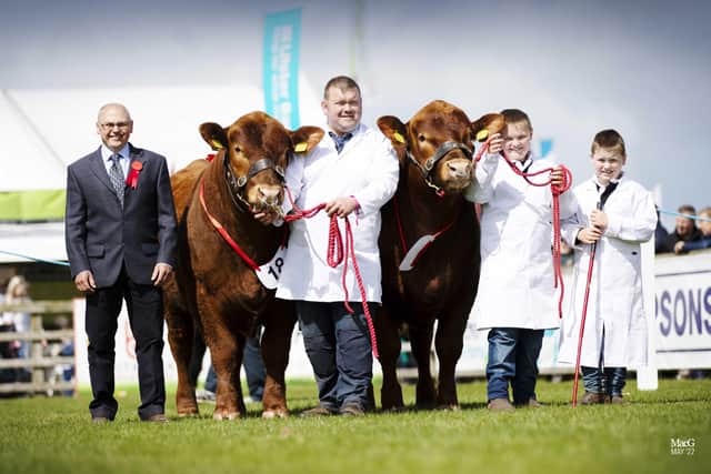 The Dodd family William, Jamie and Lewis, from Saintfield, exhibited the best pair of Aberdeen Angus cattle at Balmoral Show. Adding his congratulations is judge Brian Clark, Cumnock, Ayrshire. Picture: MacGregor Photography