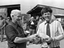 Head stockman Mr Michael Devlin presenting the top Limousin award at the performance test at the Loughall test centre in May 1982 to Mr Johnston of Hillsborough, Co Down. Picture: Farming Life/News Letter archives