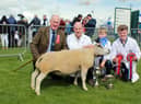 Andrew, Jaden and Jamie McCutcheon, Trillick, with their supreme champion, Bodoney Emerald ET and judge, Kevin Buckle