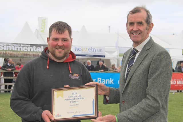HYB member John McLean, Priestland Herd, Bushmills, was one of the finalists for Holstein UK's President's Medal Award. He received the award at Balmoral Show from Holstein UK president John Jamieson. Picture: Julie Hazelton