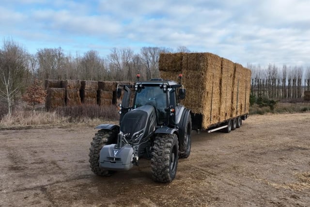 5th generation Valtra T235 hitched up to trailer of hay bails. Image: Raw Cut Television