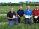 Inspecting grass that was cut on Wednesday of this week (left to right) Adrian Jamison, Lavin, Dunloy, Co Antrim; Frank Foster, Bio-Sil; David Jamison and Richard Owens, Owens’ Farm Solutions.