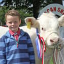 Brothers Harry and Sam Ritchie from Richhill with their reserve Charolais champion at a previous Lurgan Show. Picture: Julie Hazelton