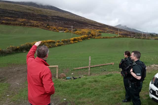 Department of Agriculture, Environment and Rural Affairs (DAERA) officials and staff from the PSNI and NIFRS assess the damage caused by recent wildfires across the Mournes.