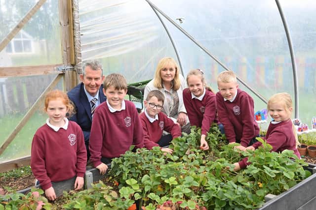 Environment Minister Edwin Poots and Education Minister Michelle McIveen pictured with pupils at Queen Elizabeth II Primary School in Pomeroy, County Tyrone.
