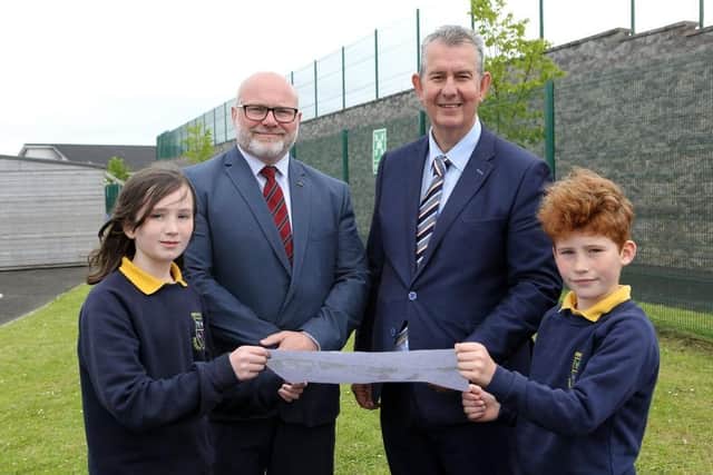 Environment Minister Edwin Poots with Ebrington Primary School Principal Brian Guthrie and P6 pupils Alex McConnell and Andrew Middleton (viewing plans for pollinator garden on which work is due to start soon).