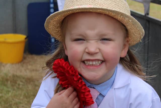 Perrie Tracey with her red ribbon from the pig section at Saintfield Show on Saturday.