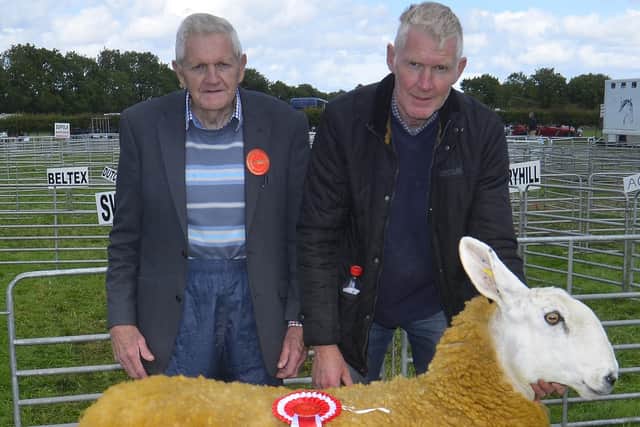 Harold and Mervyn Dickey show off their Border Leicester ewe that was Reserve Champion.