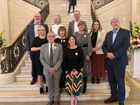 Minister John O'Dowd is pictured with representatives from Rural Community Transport Partnerships in Parliament Buildings.
