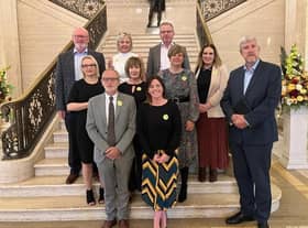 Minister John O'Dowd is pictured with representatives from Rural Community Transport Partnerships in Parliament Buildings.