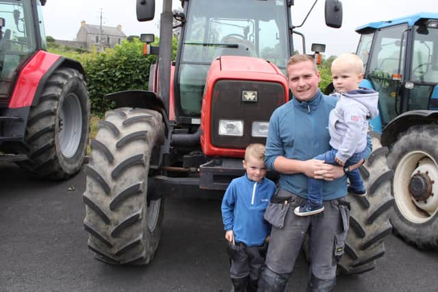 Kyle McBride brought his two sons Jack and Arthur to the tractor run at Tanvally last Friday night.