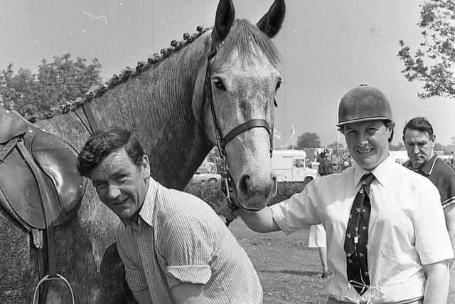 Jim Quinn from Crossgar, Co Down, adjusts studs on Glenlagan, owned by Billy McIlroy, Dromara, as rider, Margie Lowry, Crossgar, looks on a the Portadown Show in June 1982. Picture: Farming Life/News Letter archives