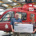 Johnston and Alison Gilmore presenting Kerry Anderson from Air Ambulance NI charity with a cheque for £6,200 from their Bluebell and Birdsong fundraiser.
