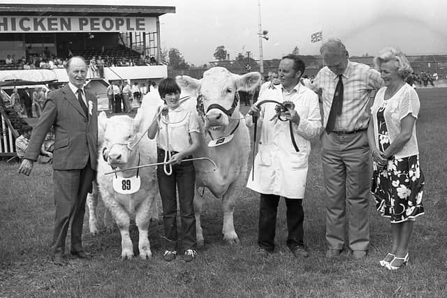 It was a proud moment for Mr Albert Connolly of Comber, Co Down, after his Charolais cow was judged champion of all breeds at the Ballymena Show in June 1982. Holding the champion is Mr Connolly’s daughter, Alison. Mrs Robert Orr presented the Ballymena Livestock Mart sash in honour. On the left is the judge, Mr James Biggar from Scotland, also in the picture is Mr Brian Smith of the Ballymena branch of the Bank of Ireland, sponsor of the championship prize. Picture: Farming Life/News Letter archives