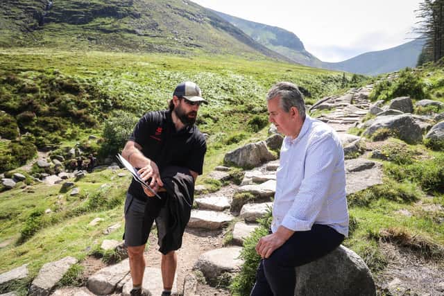 Jesse McFadden, Mournes Path Work Ranger from National Trust, shows Environment Minister Edwin Poots how funding from the Environment Fund has helped improve trails on Slieve Donard in Newcastle.