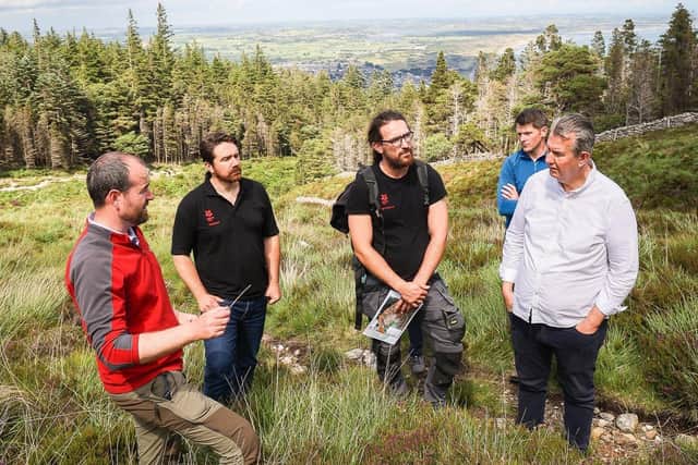 Environment Minister Edwin Poots pictured with Kevin Duncan and a delegation from the National Trust Wildfire Recovery Project as he sees first-hand works undertaken in response to the wildfires of 2021.This project received funding under the Environment Fund.