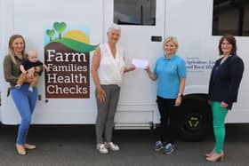 Lorraine Sampson, centre, presents a cheque for £5,500 from the Alistair Sampson Memorial Fund to Farm Families Health Check Programme Coordinator Christina Faulkner. Also included, are from left, Samantha Sampson with baby Alistair Sampson and Nurse Yvonne Carson.