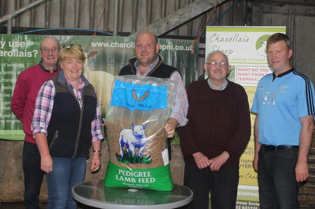 Liz Watson first in the Stock Judging Competition receives her 1st Prize Bag of Strabane Mills Sheep Meal from William McAllister, Judge. Norman McMordie, Tommy Fenton and Ian Goudy tied for 2nd place.