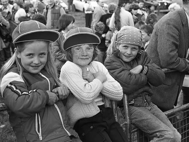 Claire Mahon, left, and her twin sister Julie, right, and Geraldine Mason, pictured in July 1981 cheering on the competitors in the Portaferry Gala Bass Donkey Derby. Picture: News Letter archives