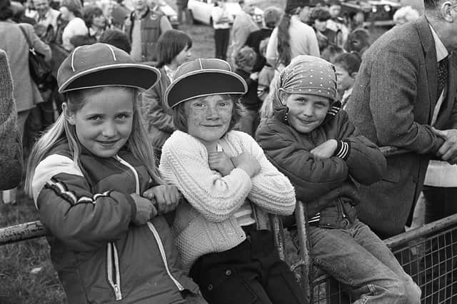 Claire Mahon, left, and her twin sister Julie, right, and Geraldine Mason, pictured in July 1981 cheering on the competitors in the Portaferry Gala Bass Donkey Derby. Picture: News Letter archives
