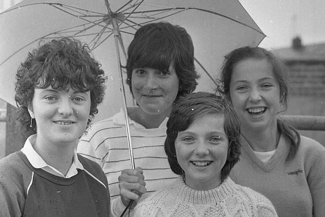 Lisnaskea Young Farmers’ Club members Janet Coulter, Hazel Magee and Lorraine and Ruth Coulter take refuge under an umbrella during one of the showers at the Enniskillen (Fermanagh) Show in August 1982. Picture: Farming Life/News Letter archives