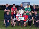 Members of Lisbellaw YFC with the Rosemary Cooper shield after winning the junior title at the YFCU 2022 tag rugby tournament at Dromore Rugby Club, Co Down. The winning team are pictured with Rodney Brown, head of agribusiness, Danske Bank (front left) and Peter Alexander, Young Farmers' Clubs of Ulster's president, (front right)