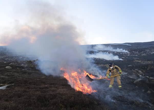 NEWCASTLE, NORTHERN IRELAND - APRIL 24: Firefighters tackle the blaze on Slieve Donard mountain on April 24, 2021 in Newcastle, Northern Ireland. The Northern Ireland Fire and Rescue Service have been tackling the moorland and gorse fire on the slopes of Slieve Donard since Friday and have now declared the blaze a major incident. Police have urged members of the public to stay away from the area as firefighters assisted by helicopters from the Irish Air Corp continue to tackle the fire. (Photo by Charles McQuillan/Getty Images)