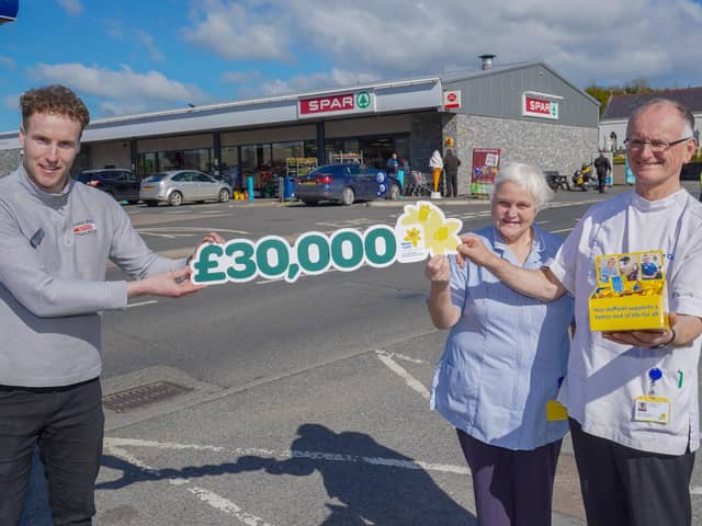 David Lavery from Trainor Bros SPAR, Pontyzpass celebrates with Marie Curie nurses Paul Rooney and Jenny Steen after SPAR shoppers raised £30,000 in just six weeks for the SPAR NI Buy A Bunch to Give A Bunch initiative in support of Marie Curie’s Great Daffodil Appeal.Photo by Aaron McCracken