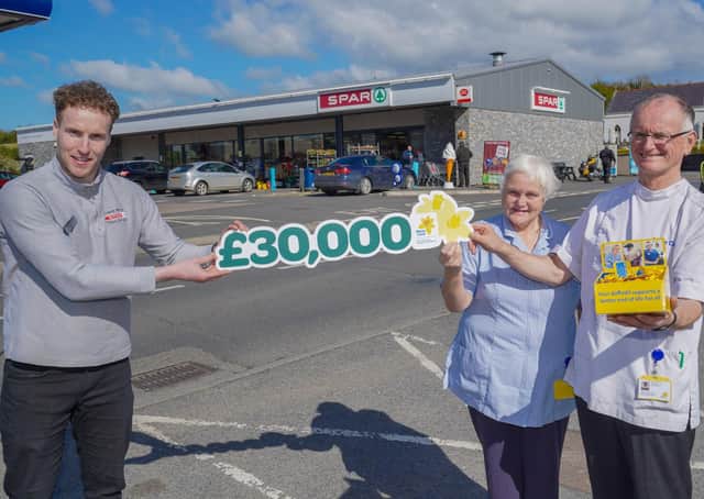 David Lavery from Trainor Bros SPAR, Pontyzpass celebrates with Marie Curie nurses Paul Rooney and Jenny Steen after SPAR shoppers raised £30,000 in just six weeks for the SPAR NI Buy A Bunch to Give A Bunch initiative in support of Marie Curie’s Great Daffodil Appeal.Photo by Aaron McCracken