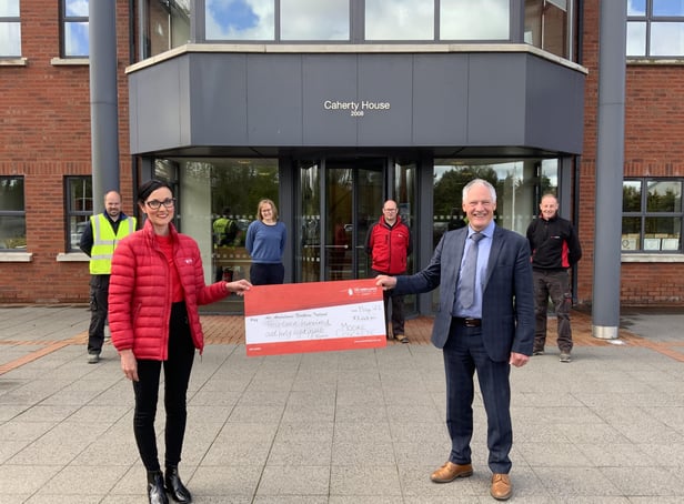 Moore Concrete managing director Wilbert Moore presents a cheque for £1448.80 to Kerry Anderson; Head of Fundraising at Air AmbulanceNorthern Ireland