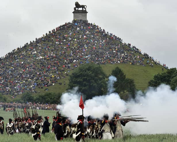 People sit on the Lion's Mound, around the lion monument of the Battle of Waterloo during a re-enactment of the 1815 Battle of Waterloo between the French army led by Napoleon and the Allied armies led by the Duke of Wellington and Field-Marshal Blucher, on June 20, 2010, in Waterloo. On June 18, 1815, Napoleon led his 72,000-strong army into battle with 120,000 mostly British and Prussian soldiers on the gently rolling plateau of Waterloo. For a long time the two forces remained in a bloody embrace, but at the end of the afternoon the French emperor's Great Army was routed at the hands of the Duke of Wellington and Field Marshal Bluecher   . AFP PHOTO / GEORGES GOBET (Photo credit should read GEORGES GOBET/AFP via Getty Images)