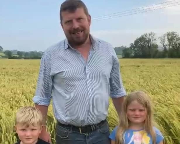 Pictured in the field of winter barley, Robert Copeland from the UFU South West Down Group and his children Ernie and Katie, who was placed third in the 2021 UFU winter barley cereal competition.