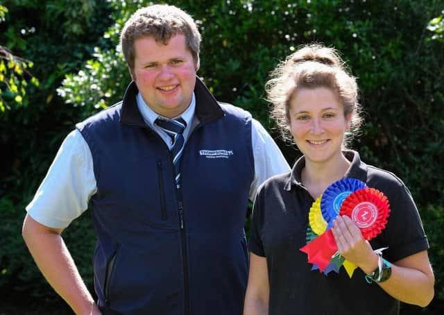 Jessica Hall, treasurer, NI Holstein Young Breeders' Club, discusses sponsorship of the forthcoming calf show with Phil Donaldson, Thompsons, sponsor. Photograph: Columba O'Hare/ Newry.ie
