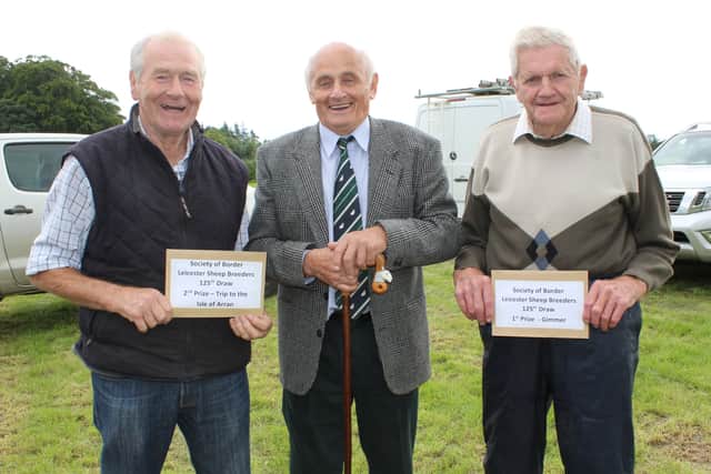 Coote Geelan and Harold Dickey being congratulated by Tom Nelson (centre) on their winning raffle prizes at the 125th Society of Border Leicester Sheep Breeders Draw.