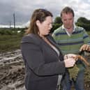 DARD Minister Michelle Gidernew surveys the effects of flooding on the farm of John Sloane near Lisburn in August 2008. Picture: Darryl Mooney/Mooney Media/Farming Life archives