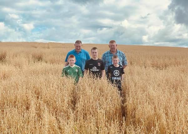 Mark and Paul Russell pictured with Mark’s sons in their oats field.