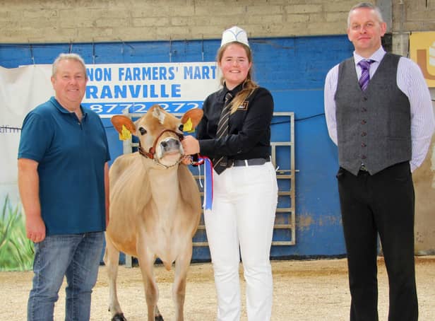 Aisla Fleming, Seaforde, was the supreme champion in the Jersey showmanship section at the 18th Multi-Breed Dairy Calf Show, held at Dungannon. Adding their congratulations are Mark Logan, Ulster Jersey Cattle Club; and judge David Gray. Picture: Julie Hazelton