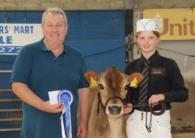 Reserve champion in the Jersey showmanship section was Amy McNeely from Magheramason. Included is Mark Logan, Ulster Jersey Cattle Club. Picture: Julie Hazelton
