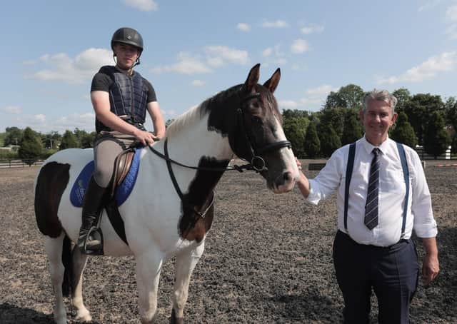 Minister Edwin Poots takes a tour of the equine facilities at CAFRE’s Enniskillen campus. Minister Poots is pictured with student Adam Kelly