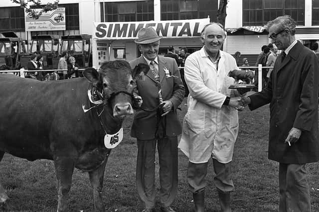 Mr Oliver Campbell, left, secretary of the NI Limousin Cattle Club, looks on as Mr William Mulligan, on behalf of the club, presents a figurine of a Limousin bull to Mr William Spiers in recognition of his services of inspection of the animals. Picture: Farming Life archives